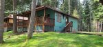 Spacious cabin with a large deck, equipped with a propane grill and plenty of seating.